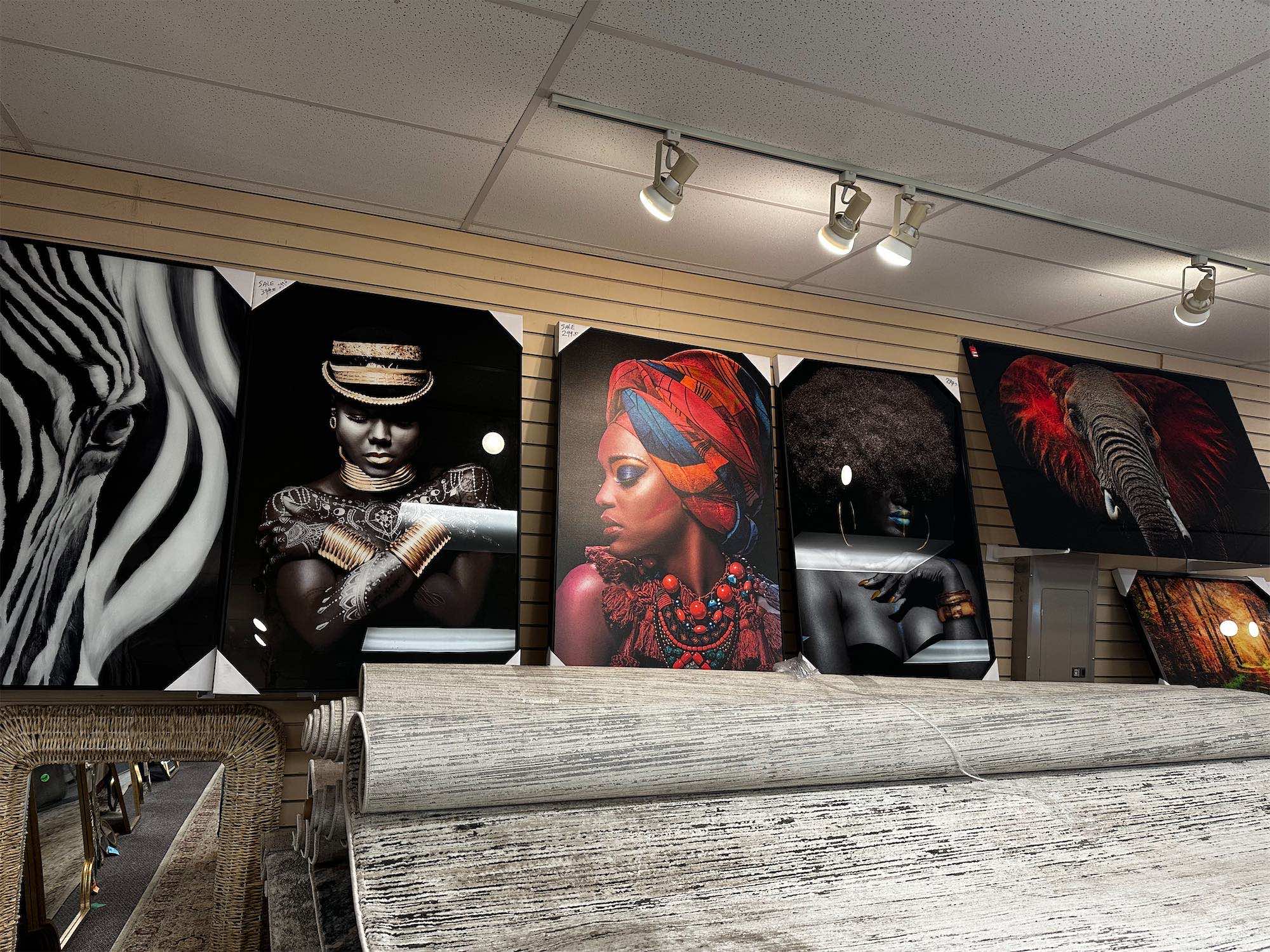 a wall with pictures of women and feathers